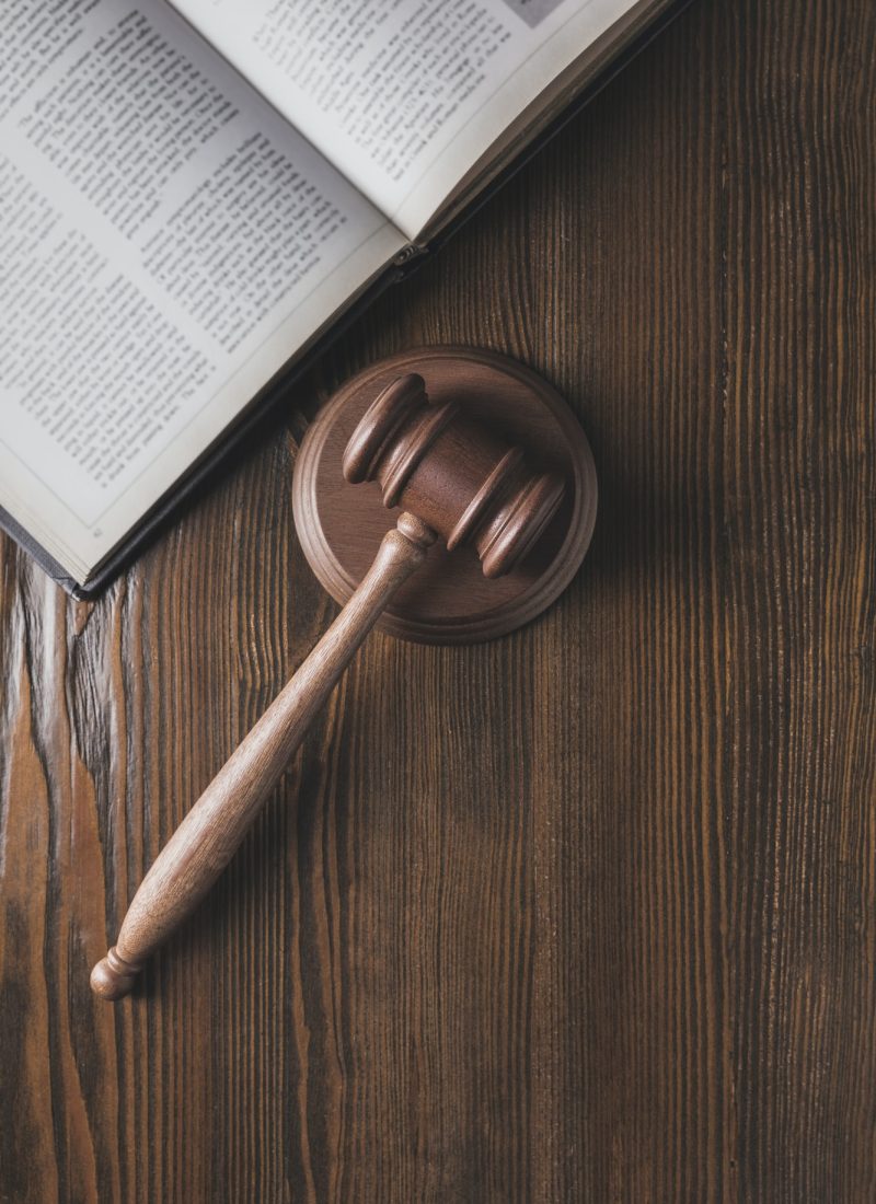 opened-juridical-book-with-hammer-on-wooden-table-law-concept.jpg